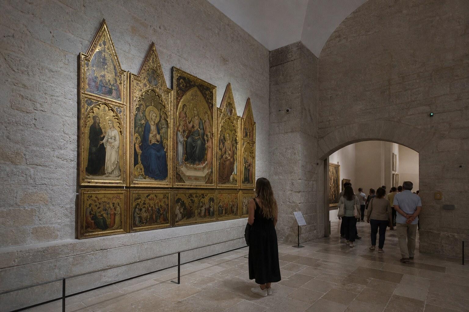 Visitor viewing medieval religious art in a Girona gallery