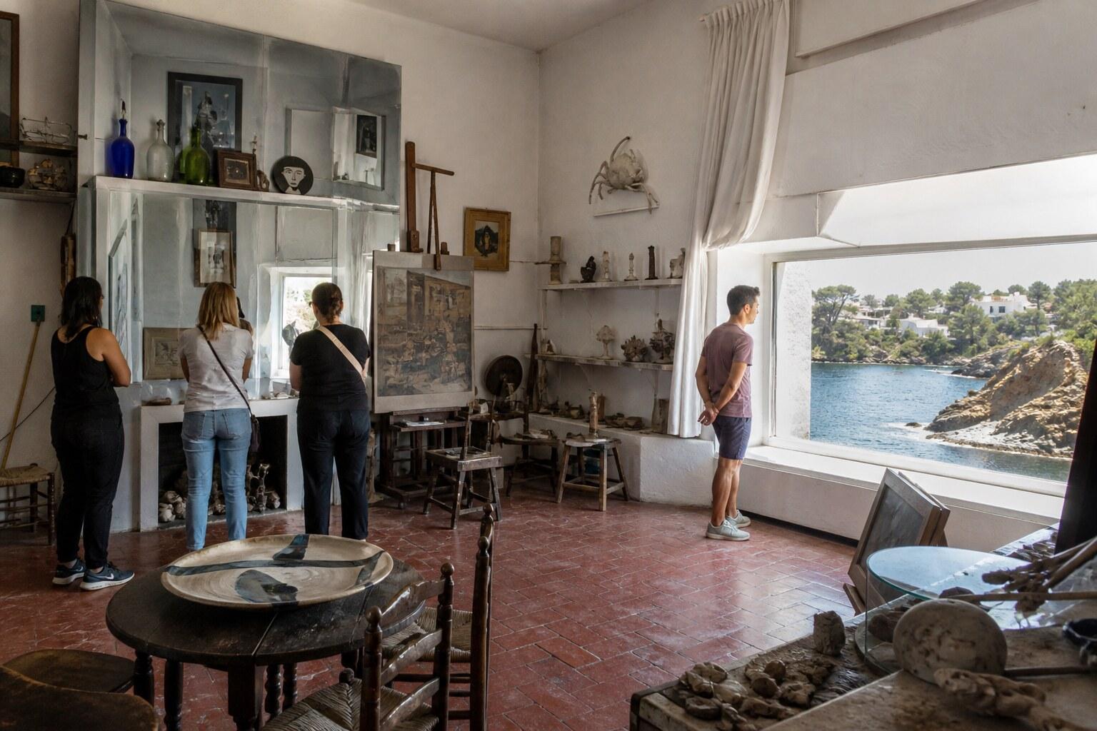 Visitors inside Dalí’s white studio rooms at Portlligat